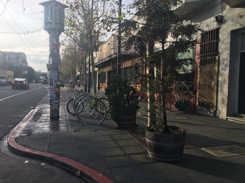 This SF bulb-out shows how they extend the sidewalk and create more space for bike parking and other amenities.